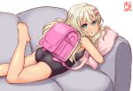  1girl artist_logo ass backpack bag barefoot black_swimsuit blonde_hair blue_eyes bow commentary_request competition_school_swimsuit couch dated grecale_(kantai_collection) hair_ornament hairclip kanon_(kurogane_knights) kantai_collection long_hair looking_at_viewer lying on_stomach pillow pink_bow randoseru school_swimsuit simple_background solo swimsuit tan wavy_hair white_background 