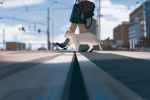  1girl animal bag blurry blurry_background building cat city clouds commentary day depth_of_field english_commentary highres legs loafers lower_body original outdoors pleated_skirt road school_uniform shoes skirt sky snatti socks solo stuffed_animal stuffed_toy walking 