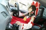  black_hair bow brown_eyes brown_hair car_interior car_seat cosplay detached_sleeves driving frilled_bow frills gear_shift hair_bow hair_tubes hakurei_reimu hakurei_reimu_(cosplay) highres long_hair noelsahelangi nontraditional_miko photorealistic red_bow red_shirt red_skirt shirt skirt solo touhou vehicle_interior wheel wide_sleeves yellow_neckwear 