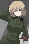  1girl absurdres aikir_(jml5160) blonde_hair brown_gloves cowboy_shot dutch_angle expressionless girls_und_panzer gloves green_eyes hand_in_hair highres katyusha_(girls_und_panzer) looking_at_viewer pravda_military_uniform short_hair solo solo_focus 