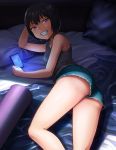 1girl black_hair cellphone commentary denim denim_shorts grin hashi lying on_bed on_side original phone short_hair short_shorts shorts smartphone smile solo tank_top upshorts violet_eyes 