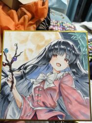  1girl bamboo black_hair bow bowtie branch chinese_commentary collared_shirt commentary_request frilled_shirt_collar frills full_moon highres houraisan_kaguya jeweled_branch_of_hourai l0e9s29p long_hair long_sleeves looking_at_viewer moon photo_(medium) pink_shirt red_eyes red_skirt shikishi shirt skirt smile solo touhou traditional_media very_long_hair white_bow white_bowtie wide_sleeves 