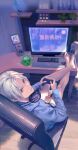  1boy barefoot chair controller crossed_ankles cup feet_on_table final_fantasy final_fantasy_xiv game_controller highres hood hood_down hoodie keyboard_(computer) looking_at_viewer looking_back monitor mouse_(computer) mug nutkin shelf short_hair sitting solo thancred_waters white_hair yellow_eyes zxin 