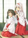  2girls brown_eyes commentary_request dark_green_hair full_body green_eyes hairband hakama japanese_clothes kantai_collection kimono kneeling long_hair mitsuyo_(mituyo324) multiple_girls red_hairband red_hakama seiza shoukaku_(kantai_collection) sitting smile tatami twintails tying white_hair white_kimono zuikaku_(kantai_collection) 