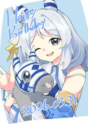  1girl absurdres animal_ears bare_shoulders brown_eyes commentary_request creature_and_personification detached_sleeves dress ear_covers grey_hair happy_birthday highres hishi_miracle_(miracle_make-up!)_(umamusume) hishi_miracle_(racehorse) hishi_miracle_(umamusume) holding horse horse_ears horse_girl looking_at_viewer medium_hair muchi3333 one_eye_closed open_mouth personification real_life smile umamusume white_dress 