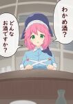  1girl blue_headwear breasts commentary counter green_eyes highres indoors kanpa_(campagne_9) large_breasts looking_at_viewer okunoda_miyoi open_mouth pink_hair short_hair short_sleeves solo tokkuri touhou translated upper_body whale_hat 