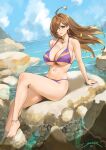  1girl ahoge bangs bare_shoulders beach bikini blue_sky blush breasts brown_eyes brown_hair collarbone cross cross_earrings earrings hair_over_one_eye highres jewelry knee_up kono_subarashii_sekai_ni_shukufuku_wo! large_breasts latin_cross legs long_hair looking_at_viewer navel purple_bikini rock sendrawz sitting sky smile swimsuit wiz_(konosuba) 