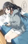  1girl absurdres bangs black_hair black_legwear blue_eyes blurry blurry_background blush commentary_request controller depth_of_field drawstring eyebrows_visible_through_hair game_controller grey_hoodie highres holding hood hood_down hoodie indoors kneehighs long_hair long_sleeves looking_away on_bed open_mouth original pentagon_(railgun_ky1206) ponytail puffy_long_sleeves puffy_sleeves ribbed_legwear short_shorts shorts sidelocks sitting sitting_on_bed sleeves_past_wrists solo translation_request v-shaped_eyebrows very_long_hair white_shorts wooden_floor 