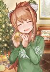  1girl :d alternate_costume bangs bow brown_hair buchi0122 christmas christmas_ornaments christmas_tree closed_eyes collarbone commentary_request doki_doki_literature_club facing_viewer food green_eyes green_sweater hair_ribbon highres holding holding_food indoors long_hair long_sleeves looking_at_viewer monika_(doki_doki_literature_club) open_mouth ponytail ribbon sidelocks smile solo sweater 