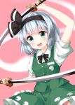  1girl bangs black_bow black_hairband black_neckwear blunt_bangs bow bowtie buttons collared_shirt eyebrows_visible_through_hair ghost ghost_print green_eyes green_skirt green_vest hairband highres hitodama holding holding_sword holding_weapon katana konpaku_youmu konpaku_youmu_(ghost) looking_at_viewer medium_hair multiple_swords open_mouth pink_background puffy_short_sleeves puffy_sleeves ruu_(tksymkw) shirt short_sleeves silver_hair simple_background skirt skirt_set solo sword teeth touhou v-shaped_eyebrows vest weapon white_shirt 