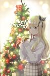  1girl bangs black_ribbon blonde_hair blue_eyes blurry blurry_background blush christmas christmas_ornaments christmas_tree closed_mouth commentary_request depth_of_field eyebrows_visible_through_hair hair_ribbon hands_up highres holding juliet_persia kishuku_gakkou_no_juliet long_hair merry_christmas natsupa official_art plaid plaid_skirt ribbon skirt sleeves_past_wrists smile solo standing star_(symbol) sweater turtleneck turtleneck_sweater very_long_hair white_sweater 
