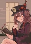  1girl bangs black_headwear book brown_hair chinese_hat crossed_legs flower flower-shaped_pupils genshin_impact hair_flaps hat holding holding_book hu_tao long_hair long_sleeves looking_at_viewer plum_blossoms red_eyes sitting smile solo twintails very_long_hair waxgroud wide_sleeves 