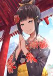  1girl alternate_hairstyle bangs black_kimono blue_sky blunt_bangs clouds eyebrows_visible_through_hair floral_print flower green_eyes hair_bun hair_flower hair_ornament hairpin hands_together hatsumoude hayaoki_(asagi-iro_seishun-bu) highres japanese_clothes kimono kurosawa_dia light_blush light_particles long_sleeves love_live! love_live!_sunshine!! mole mole_under_mouth new_year outdoors praying red_flower sash sidelocks sky smile solo temple traditional_clothes upper_body wide_sleeves x_hair_ornament yellow_sash 