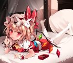  1girl ascot blonde_hair blush flandre_scarlet food hat hat_ribbon highres looking_at_viewer lying mob_cap mouth_hold on_bed on_stomach pantyhose pillow pocky puffy_short_sleeves puffy_sleeves red_eyes red_skirt red_vest ribbon shirt short_sleeves skirt solo touhou vest white_headwear white_legwear white_shirt wings wrist_cuffs yellow_neckwear zerocat 