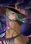  1girl absurdres bangs black_headwear blouse blue_eyes blurry blurry_foreground blush bokeh bow building cityscape closed_mouth clouds cloudy_sky commentary_request depth_of_field dutch_angle eyeball eyebrows_visible_through_hair frills green_hair green_skirt hair_between_eyes hat hat_bow highres kirikaze_ren komeiji_koishi looking_at_viewer looking_back night night_sky railing short_hair skirt sky smile solo standing star_(sky) starry_sky third_eye touhou upper_body wide_sleeves yellow_blouse yellow_bow 