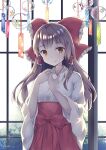  1girl artist_name bangs bow breasts brown_eyes brown_hair closed_mouth day eyebrows_visible_through_hair hair_bow hair_ornament hair_tubes hakurei_reimu hands_up indoors japanese_clothes long_hair looking_at_viewer mikako sidelocks smile solo touhou wind_chime 