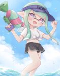  1girl :d bangs black_shorts blue_headwear blue_sky blunt_bangs blunt_ends clothes_writing clouds cloudy_sky commentary day dolphin_shorts domino_mask droplet english_commentary eyebrows_visible_through_hair fang green_hair highres holding holding_weapon inkling inkling_(language) long_hair looking_at_viewer mask midriff navel open_mouth outdoors pioxpioo pointy_ears shirt short_shorts shorts skin_fang sky smile solo splatoon_(series) splatoon_2 splattershot_(splatoon) standing t-shirt tentacle_hair tied_shirt violet_eyes visor_cap w_arms wading water weapon white_shirt 