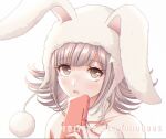  1girl animal_ears animal_hood bangs blush bunny_hood commentary criis-chan dangan_ronpa_(series) dangan_ronpa_2:_goodbye_despair detached_collar english_commentary eyebrows_visible_through_hair flipped_hair hand_up holding hood light_brown_hair looking_at_viewer nanami_chiaki neck_ribbon official_alternate_costume open_mouth pink_eyes playboy_bunny portrait red_ribbon ribbon shiny shiny_hair simple_background solo twitter_username white_background 