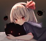  1girl alternate_costume black_hairband black_shirt blonde_hair blush commentary darkness from_side hair_ribbon hairband looking_at_viewer lying on_stomach red_eyes red_ribbon ribbon rumia sailor_collar shirt short_hair short_sleeves smile solarisu solo touhou upper_body 