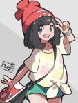  1girl beanie black_hair collarbone eyebrows_visible_through_hair green_shorts grey_background hat hiisu_(s-1104-d) jewelry looking_at_viewer pokemon pokemon_(game) pokemon_sm red_headwear ring selene_(pokemon) shirt short_shorts short_sleeves shorts signature simple_background smile solo upper_teeth v 