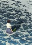  1girl bob_cut brown_hair from_above from_behind highres hiko_(scape) holding leaf ocean original pleated_skirt school_uniform shadow shirt short_hair skirt solo water waves white_shirt wind 