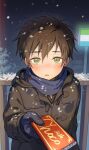  1boy bangs blush brown_coat brown_hair candy chocolate chocolate_bar coat commentary_request food gloves green_eyes hair_between_eyes hand_up highres holding incoming_gift looking_at_viewer male_focus night open_mouth original outdoors pillow_(nutsfool) scarf snow snowing solo tongue 