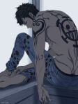  1boy arm_tattoo back back_tattoo black_eyes black_hair denim from_behind highres jeans looking_at_viewer male_focus one_piece panther_print pants pectorals pinattsu shirtless short_hair shoulder_tattoo sideburns sitting solo tattoo toned toned_male trafalgar_law 