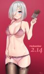  1girl absurdres artist_name bikini black_legwear blue_eyes breasts candy chocolate chocolate_bar commentary_request cowboy_shot dated food gradient gradient_background hair_ornament hair_over_one_eye hairclip hamakaze_(kancolle) highres kantai_collection large_breasts onion_(kumagaioyr) pink_bikini red_background short_hair silver_hair smile solo standing striped striped_bikini swimsuit thigh-highs valentine 