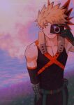  1boy bakugou_katsuki bangs bare_shoulders belt black_gloves black_pants black_shirt black_sleeves blonde_hair boku_no_hero_academia camera closed_mouth collarbone detached_sleeves english_commentary expressionless field gloves grass hair_ornament hand_in_pocket hand_up holding holding_camera male_focus one_eye_closed outdoors pants red_gloves shirt short_hair sleeveless solo spiky_hair two-tone_gloves wengwengchim 