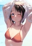  1girl armpits artist_name bangs bikini black_hair blue_eyes blush breasts collarbone commentary jonsun lifted_by_self looking_at_viewer nose_blush ocean one_eye_closed original raised_eyebrows red_bikini see-through shirt shirt_lift short_hair small_breasts solo swimsuit twitter_username undressing upper_body wet wet_clothes wet_hair white_shirt 