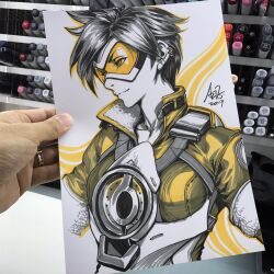  1girl 2017 art_tools_in_frame artist's_hand_in_frame bomber_jacket chest_harness closed_mouth commentary english_commentary goggles harness highres jacket marker_(medium) orange_goggles orange_outline outline overwatch photo_(medium) short_hair signature solo spiky_hair stanley_lau tracer_(overwatch) traditional_media upper_body 