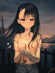  1girl asymmetrical_bangs bangs black_hair blurry blurry_background blush breasts brown_eyes casual commentary_request dark_skin dark-skinned_female denim ear_clip fireworks highres ijiranaide_nagatoro-san junkt729 light_smile lighthouse long_hair nagatoro_hayase night ocean pier small_breasts solo sparkler 