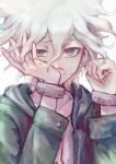  1boy a_po_(liuxiaobo0413) bangs blood blood_on_face collarbone cuffs dangan_ronpa_(series) dangan_ronpa_2:_goodbye_despair face green_jacket grey_background grey_hair hands_on_own_face hands_up hood hood_down hooded_jacket jacket komaeda_nagito long_sleeves looking_at_viewer male_focus nosebleed open_clothes open_jacket shackles shirt short_hair simple_background solo symbol_commentary upper_body white_hair white_shirt wiping_nose 