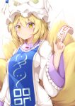  1girl animal_ears blonde_hair closed_mouth commentary_request eyebrows_visible_through_hair fox_ears fox_tail hair_between_eyes hat multiple_tails rururiaru short_hair simple_background smile solo tabard tail touhou white_background yakumo_ran yellow_eyes 