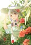  1girl absurdres alternate_costume bangs blonde_hair blue_dress camera chinese_commentary ciyana dress eyebrows_behind_hair flower forest hair_flower hair_ornament hat highres holding holding_camera holding_clothes holding_hat indie_virtual_youtuber lens_flare long_hair looking_at_viewer nature open_mouth red_flower smile solo summer sun_hat sunlight virtual_youtuber white_headwear yellow_eyes zhongchun_ci 
