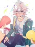  1boy 3others bangs blurry blurry_foreground blush collarbone confetti dangan_ronpa_(series) dangan_ronpa_2:_goodbye_despair food food_on_head gift green_jacket grey_eyes grey_hair grey_shirt hair_between_eyes happy_birthday highres holding jacket knee_up komaeda_nagito long_sleeves looking_at_viewer male_focus messy_hair multiple_others object_on_head off_shoulder open_clothes open_jacket plate print_shirt shirt short_hair sitting smile solo_focus suzumetarou white_shirt 