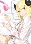  1girl absurdres animal_ears bed_sheet blonde_hair blush coat eyebrows_visible_through_hair eyes_visible_through_hair hair_ornament hairclip headphones highres hololive horns kaname_(melaninusa09) looking_at_viewer lying on_side pillow ribbon see-through sheep_ears sheep_girl sheep_horns sidelocks skirt tsunomaki_watame violet_eyes 