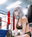  1girl abs ak-15_(girls_frontline) black_shorts black_sports_bra blurry blurry_background boxing_gloves boxing_ring braid breasts collarbone eyes_visible_through_hair french_braid girls_frontline greatspirite gym highres large_breasts long_hair punching_bag shorts silver_hair sports_bra sweat violet_eyes 