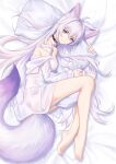  1girl absurdres animal_ear_fluff animal_ears antenna_hair bangs bare_legs bare_shoulders barefoot bed_sheet bell breasts closed_mouth collar commentary_request extra_ears fox_ears fox_girl fox_tail from_above full_body highres jingle_bell kirby_d_a large_tail long_hair long_sleeves looking_at_viewer lying medium_breasts neck_bell off_shoulder on_bed on_side original pillow pillow_hug purple_hair shirt smile tail very_long_hair violet_eyes white_shirt 