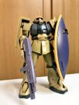  gun gundam gunpla holding holding_gun holding_shield holding_weapon mecha mobile_suit_gundam no_humans ookawara_kunio photo_(medium) reference_photo shield weapon zaku_ii_s 