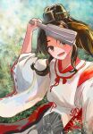  1girl absurdres bangs black_hair brown_eyes day fuuka_hatsuden grass headgear high_ponytail highres holding japanese_clothes kantai_collection long_hair looking_at_viewer miko nisshin_(kancolle) open_mouth outdoors ponytail ribbon-trimmed_sleeves ribbon_trim sidelocks solo tassel wide_sleeves 