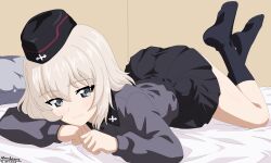  1girl absurdres ass atomlarve_(pixiv_82318148) bed black_hat black_skirt black_socks blonde_hair blue_eyes blush closed_mouth commentary feet_up girls_und_panzer hat highres indoors insignia itsumi_erika kuromorimine_military_uniform kuromorimine_school_uniform long_hair looking_at_viewer lying military_hat military_uniform on_bed on_stomach school_uniform skirt smile socks solo 