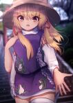  1girl animal_print bangs blonde_hair blurry blurry_background brown_headwear cowboy_shot darumoon eyebrows_visible_through_hair frog_print hand_on_own_chest highres long_sleeves looking_at_viewer medium_hair moriya_suwako open_mouth outdoors purple_skirt purple_vest shirt sidelocks skirt solo standing torii touhou tree turtleneck vest white_legwear white_shirt wide_sleeves yellow_eyes 