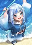  1girl :d arms_up bangs beach blue_eyes blue_hair blue_hoodie blunt_bangs blush commentary english_commentary fish_tail from_above full_body gawr_gura hair_ornament highres holding holding_weapon hololive hololive_english hood hood_down hoodie long_sleeves looking_at_viewer medium_hair multicolored_hair ocean open_mouth polearm shark_girl shark_hair_ornament shark_tail sharp_teeth shoes silver_hair smile sneakers solo streaked_hair tail takuo teeth trident two_side_up upper_teeth v-shaped_eyebrows virtual_youtuber weapon wide_sleeves 