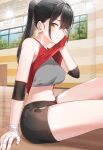  1girl armband bandages black_hair blurry_background indoors kfr legs looking_at_viewer midriff original ponytail short_shorts sitting smile sports_bra sportswear sweat wiping_face wiping_sweat yellow_eyes 