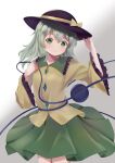  1girl blouse blush breasts cowboy_shot eyeball green_eyes green_hair green_skirt grey_background hand_up hat highres komeiji_koishi long_hair looking_at_viewer simple_background skirt small_breasts solo third_eye touhou wide_sleeves yellow_blouse ys_kosato 