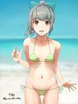  1girl artist_name ass_visible_through_thighs bangs beach bikini blue_sky blunt_bangs blurry bow breasts brown_eyes collarbone commentary_request cowboy_shot day depth_of_field green_bikini green_bow grey_hair groin hair_bow highres horizon kantai_collection long_hair looking_at_viewer navel ocean open_mouth outdoors side-tie_bikini sky small_breasts solo standing striped striped_bikini swimsuit twitter_username yuubari_(kancolle) yuushou 