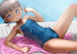  1girl absurdres bangs blue_eyes blue_swimsuit blunt_bangs brown_hair collarbone competition_school_swimsuit dark-skinned_female dark_skin flat_chest hair_bun highres long_hair looking_at_viewer lying on_side original pink_towel pool poolside sasahara_yuuki school_swimsuit solo swimsuit tan tied_hair towel 