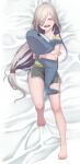  1girl ahoge asashimo_(kancolle) barefoot bed closed_eyes doll_hug full_body grey_shorts hair_over_one_eye highres kantai_collection long_hair saga_(saga_kancolle) sharp_teeth shorts silver_hair sleepwear solo stuffed_animal stuffed_shark stuffed_toy teeth 