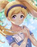  1girl bangs blonde_hair blue_shirt blurry blurry_background blush bow bow_hairband closed_mouth collarbone dappled_sunlight emily_stewart floating_hair hair_bow hairband highres highwooods idolmaster idolmaster_million_live! long_hair looking_at_viewer purple_bow purple_hairband shirt short_sleeves smile solo sunlight swept_bangs twintails upper_body violet_eyes 